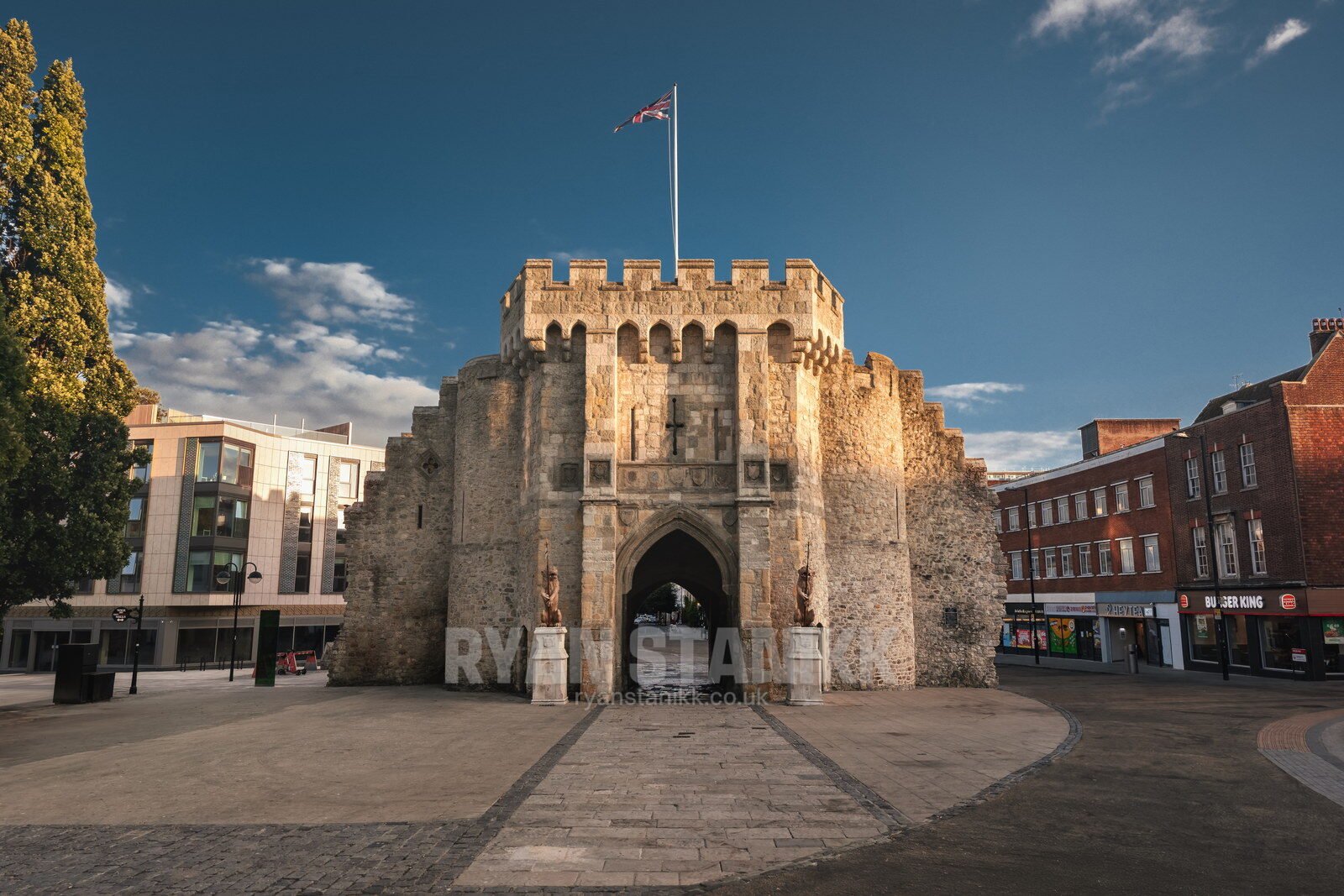 The Bargate, Southampton, photographed straight on in evening light in August 2026, with the Union flag flying above the battlements and an empty plaza in front