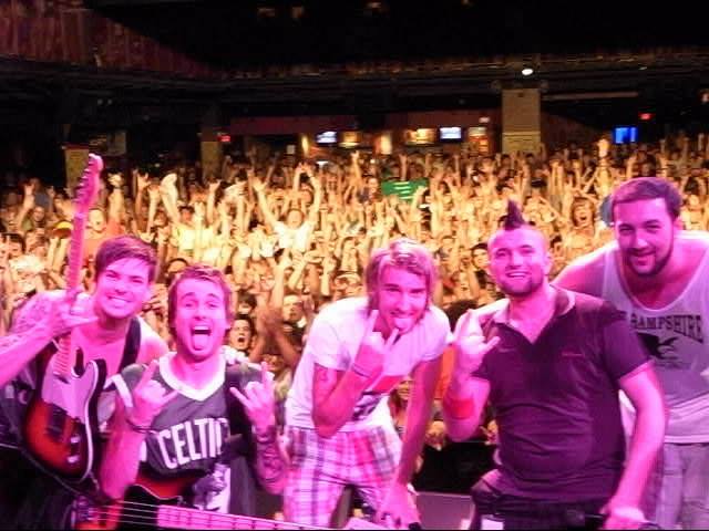 New Riot on stage with a crowd of thousands behind them during a US and Canada tour