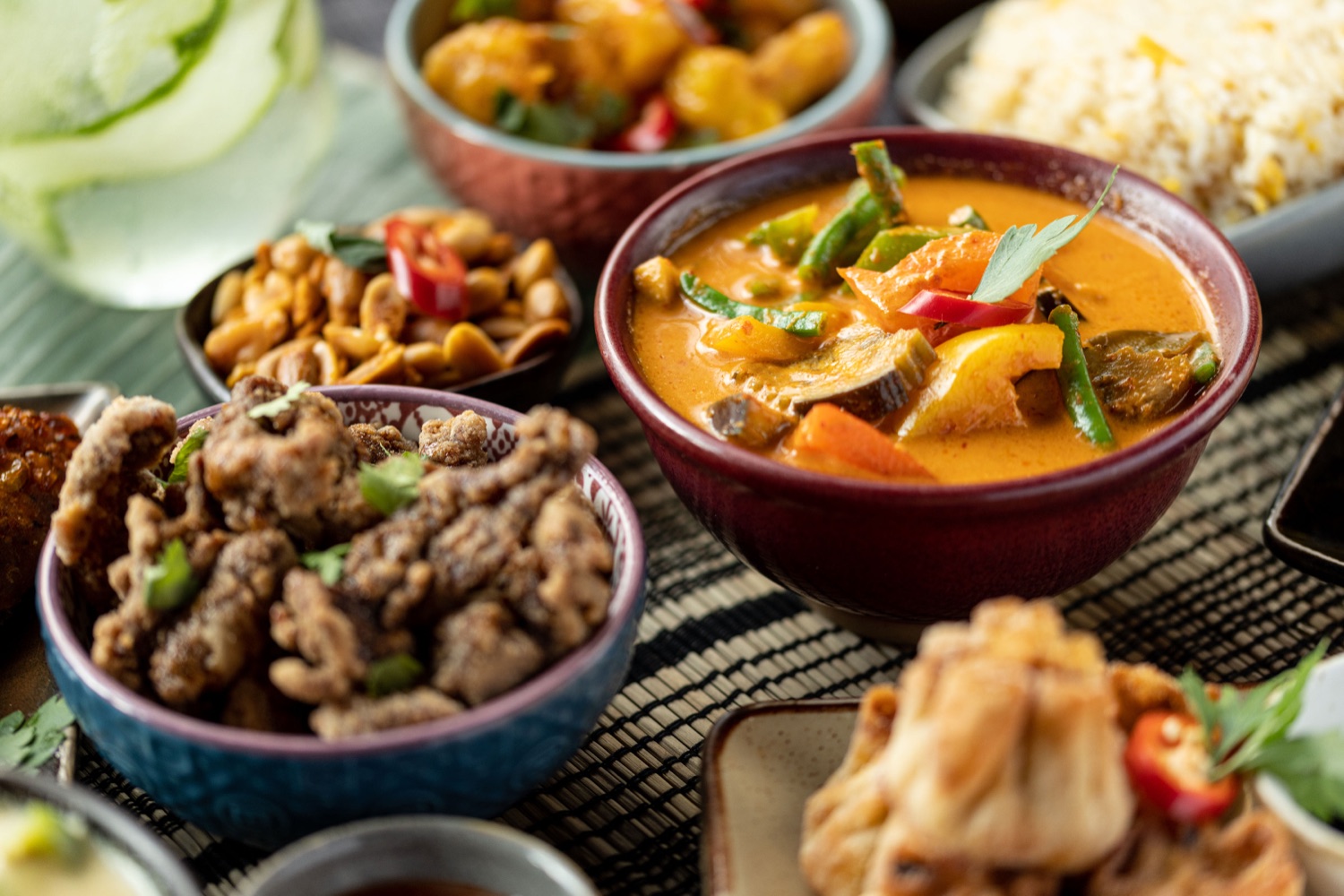 Thai sharing dishes at Mango Thai Tapas Southampton including red curry with peppers and green beans, salt and pepper fried chicken, roasted peanuts and egg fried rice, food photography by Ryan Stanikk
