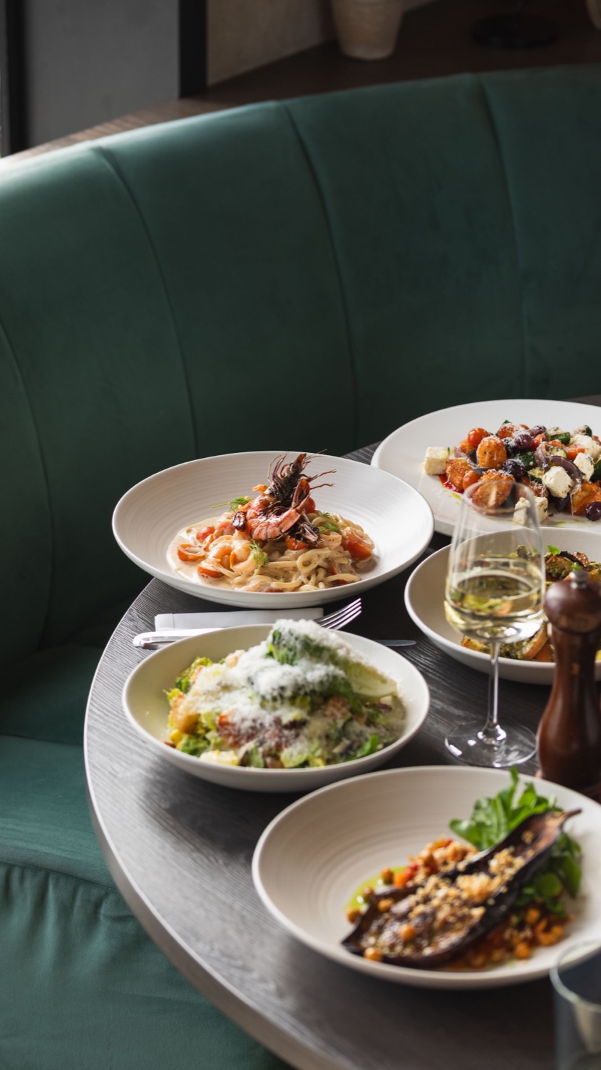 Italian summer menu spread with prawn linguine, caesar salad, bruschetta and grilled aubergine at Figurati restaurant Southampton, food photography
