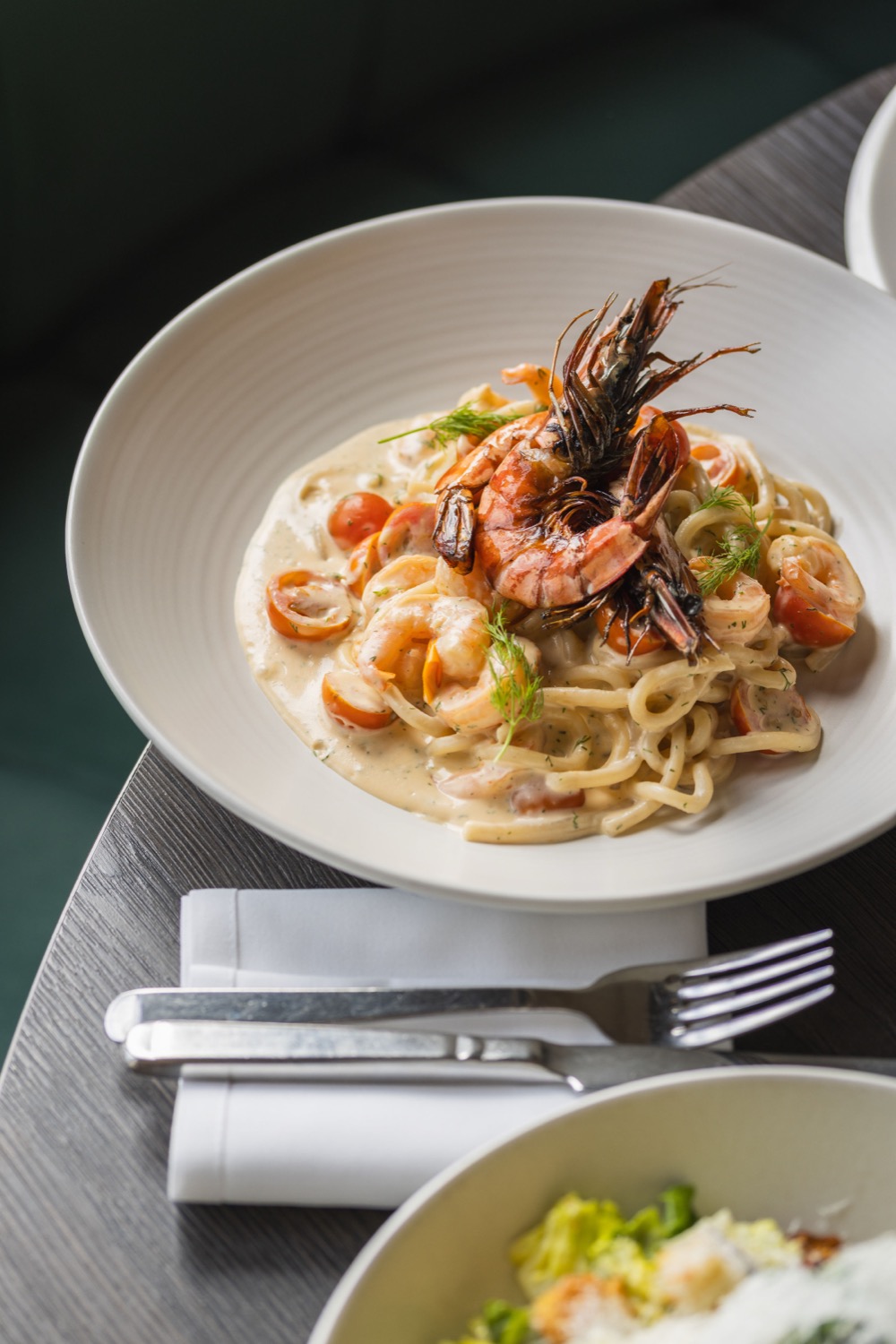 Prawn linguine in a creamy sauce with whole grilled prawns at Figurati Italian restaurant Southampton, pasta food photography