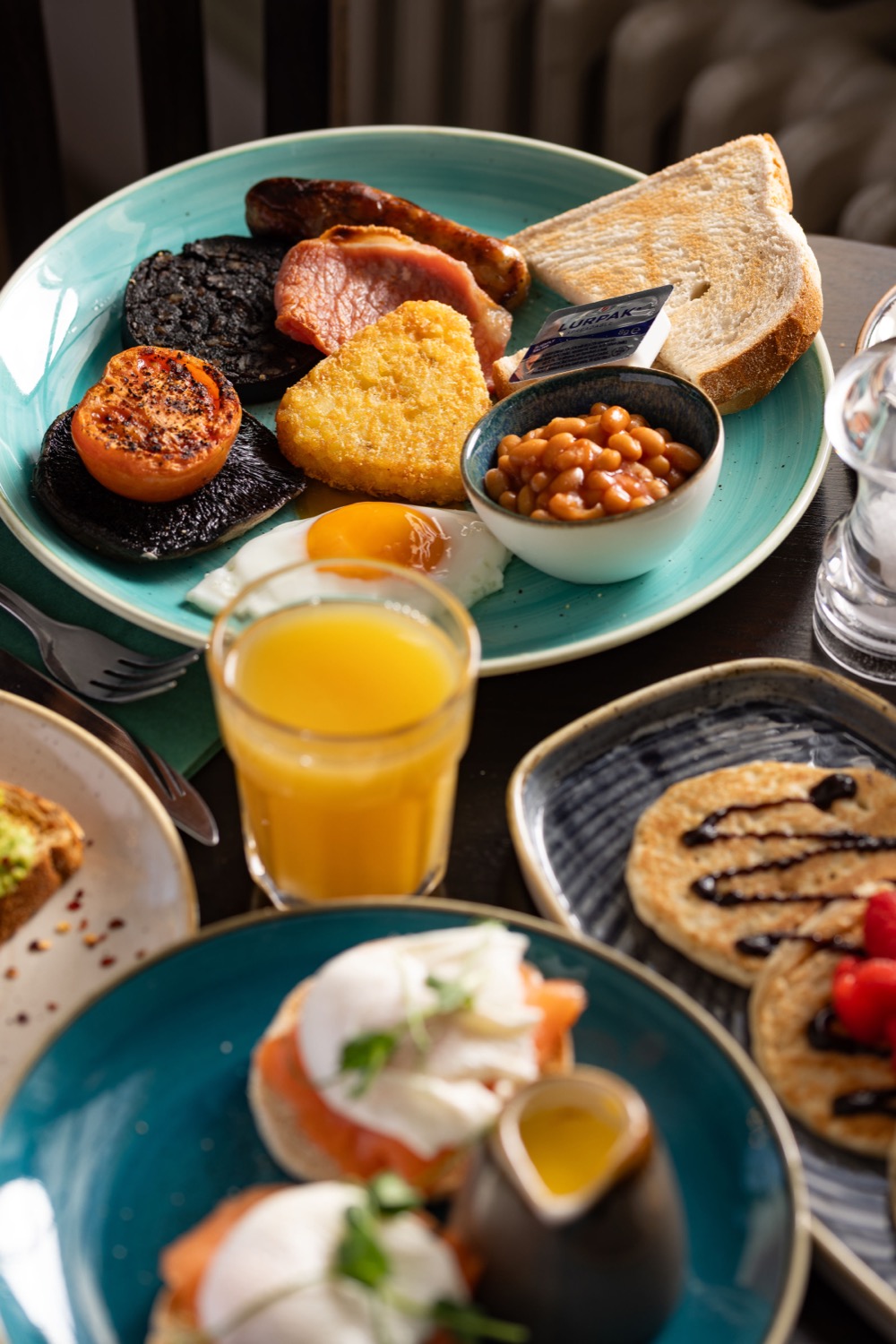 Full English breakfast with black pudding, hash brown, grilled tomato, bacon, baked beans, toast and orange juice at Mortimer Arms Southampton, breakfast food photography