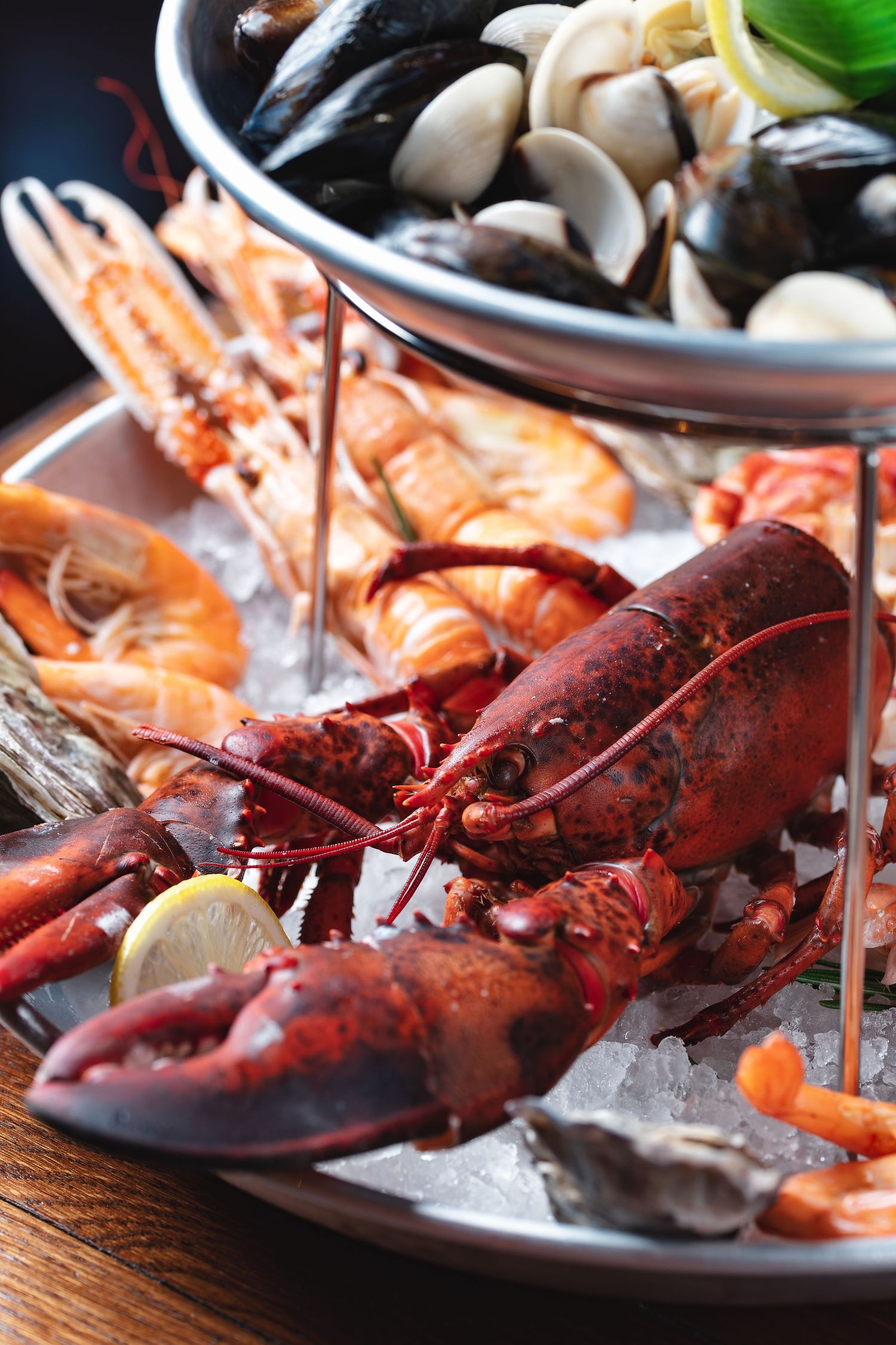 Tiered seafood platter with whole lobster, prawns and oysters on ice with mussels and clams on the upper tier at Ocean Grill restaurant, seafood food photography Southampton