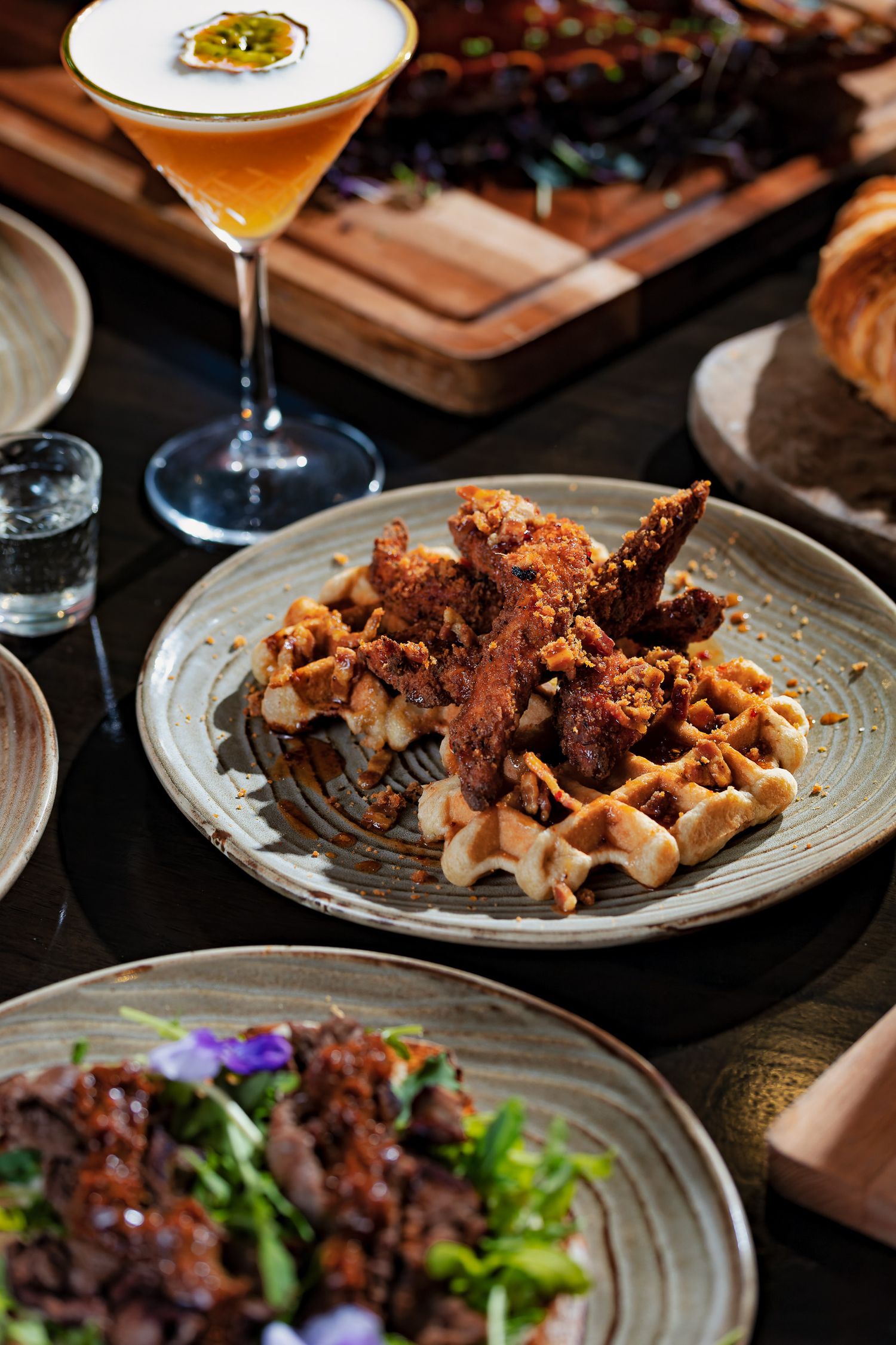 Fried chicken and waffles with a passion fruit martini cocktail at Porters Southampton, restaurant food photography