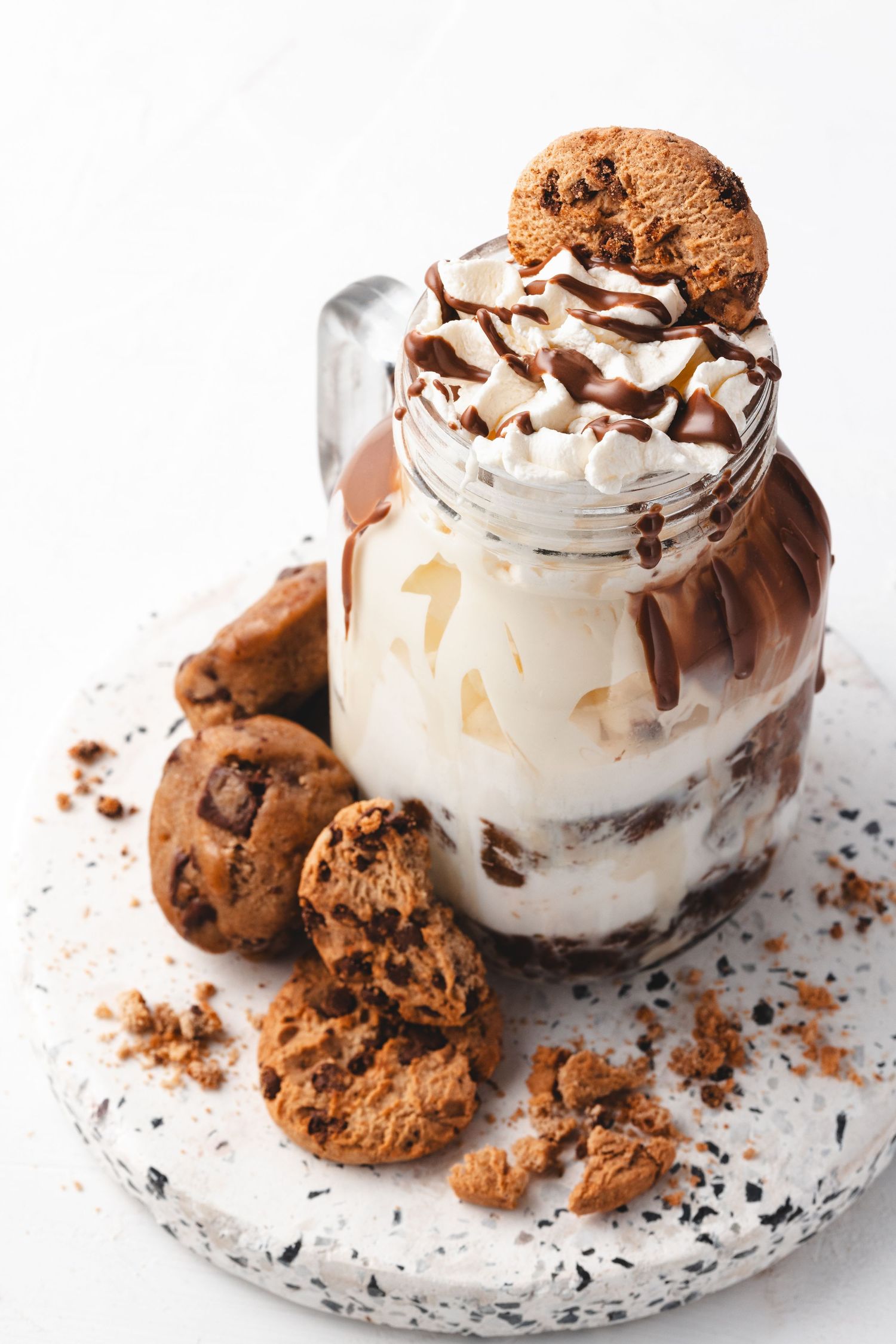 Cookie dough freakshake in a mason jar with whipped cream, chocolate sauce and chocolate chip cookies at Sprinkles dessert shop, dessert photography
