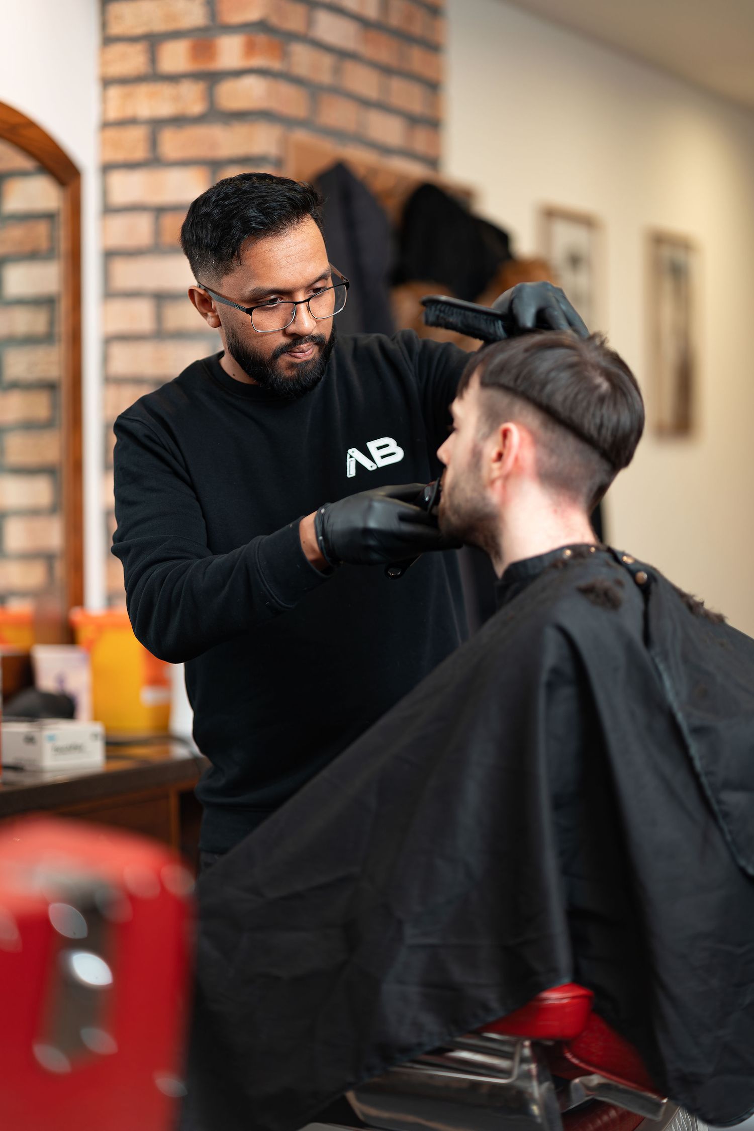 Barber trimming a client\