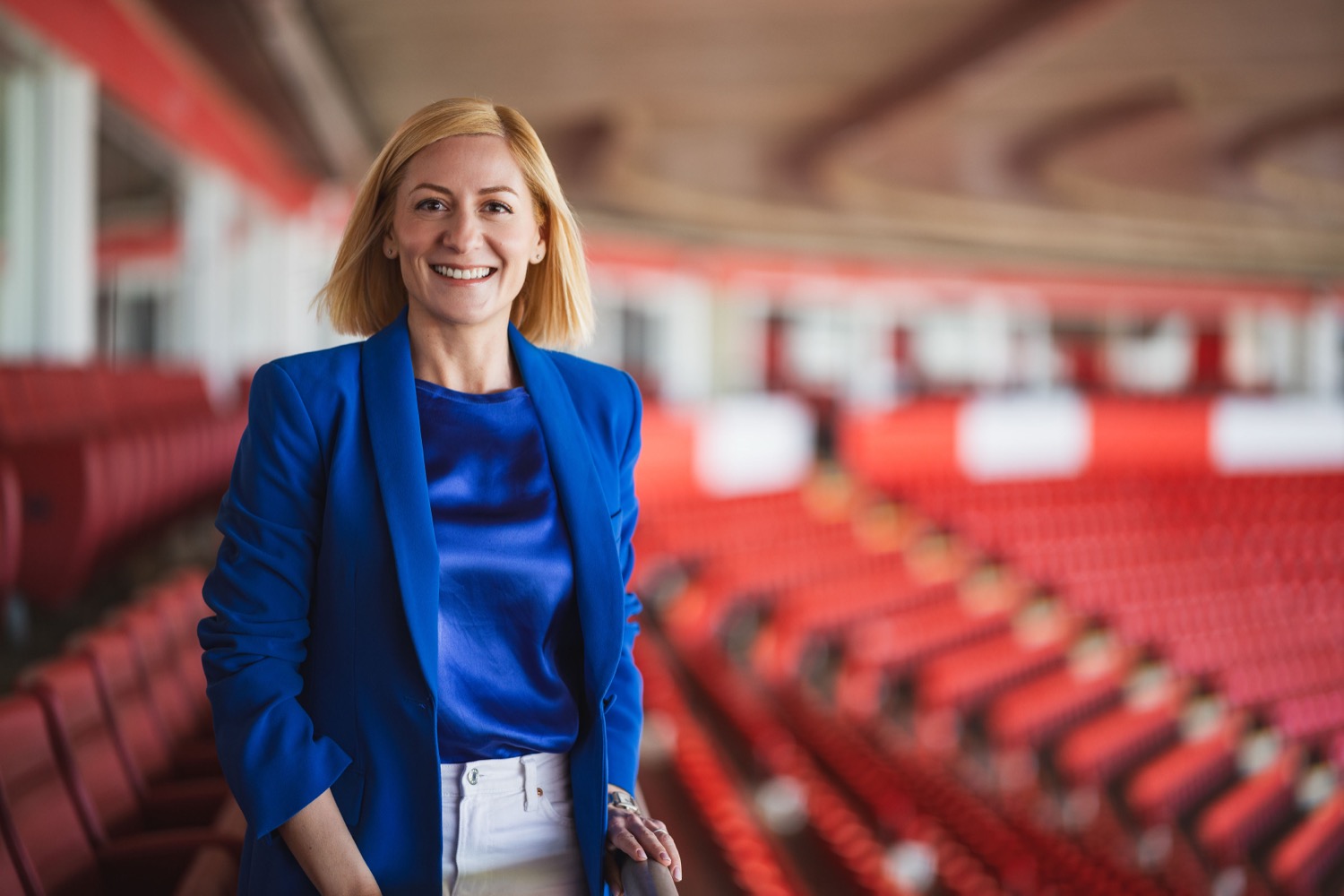 Woman in blue blazer smiling in the stands at St Marys Stadium Southampton during Lenovo production, corporate portrait photography