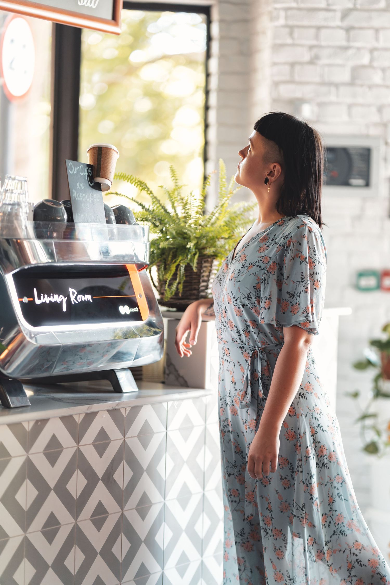Woman standing at the counter beside a coffee machine at Living Room cafe, hospitality lifestyle photography Southampton