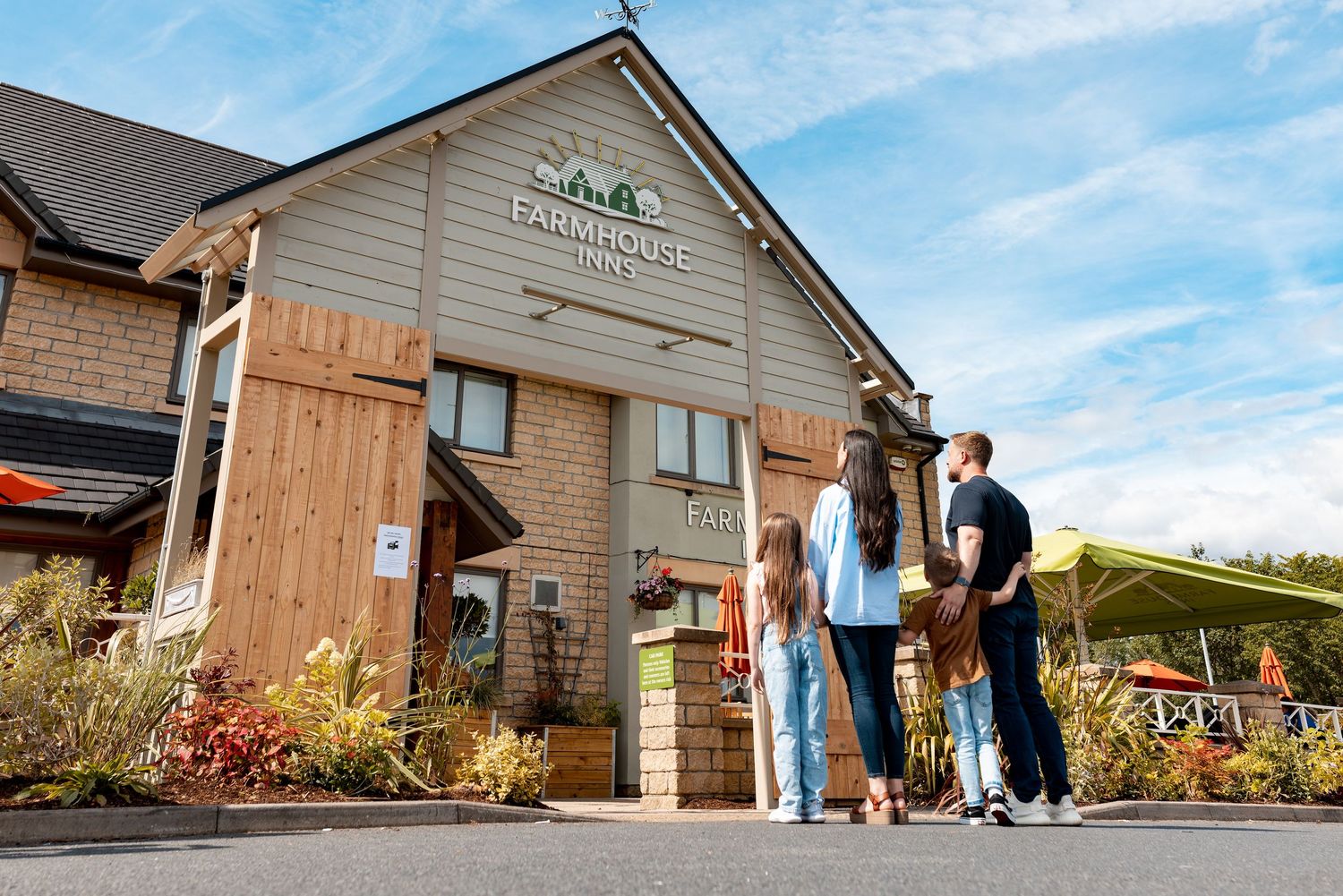 Family arriving at Farmhouse Inns restaurant on a sunny day, hospitality venue lifestyle photography