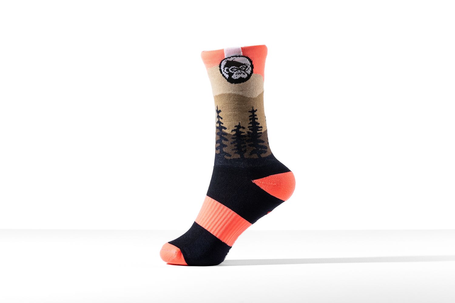 Single mountain-scene patterned sock in coral and navy standing upright on a white background for Grumpy Monkey, branded apparel product photography