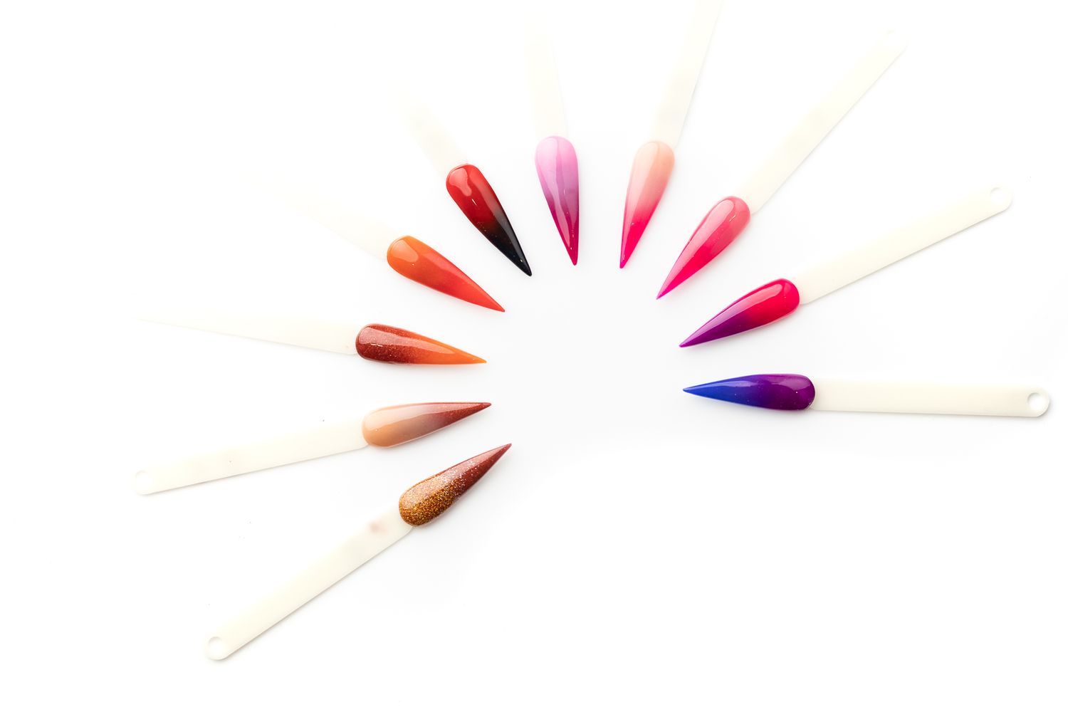Nexus dip-acrylic nail colour swatches fanned out in a semicircle on a white background, beauty product photography Southampton