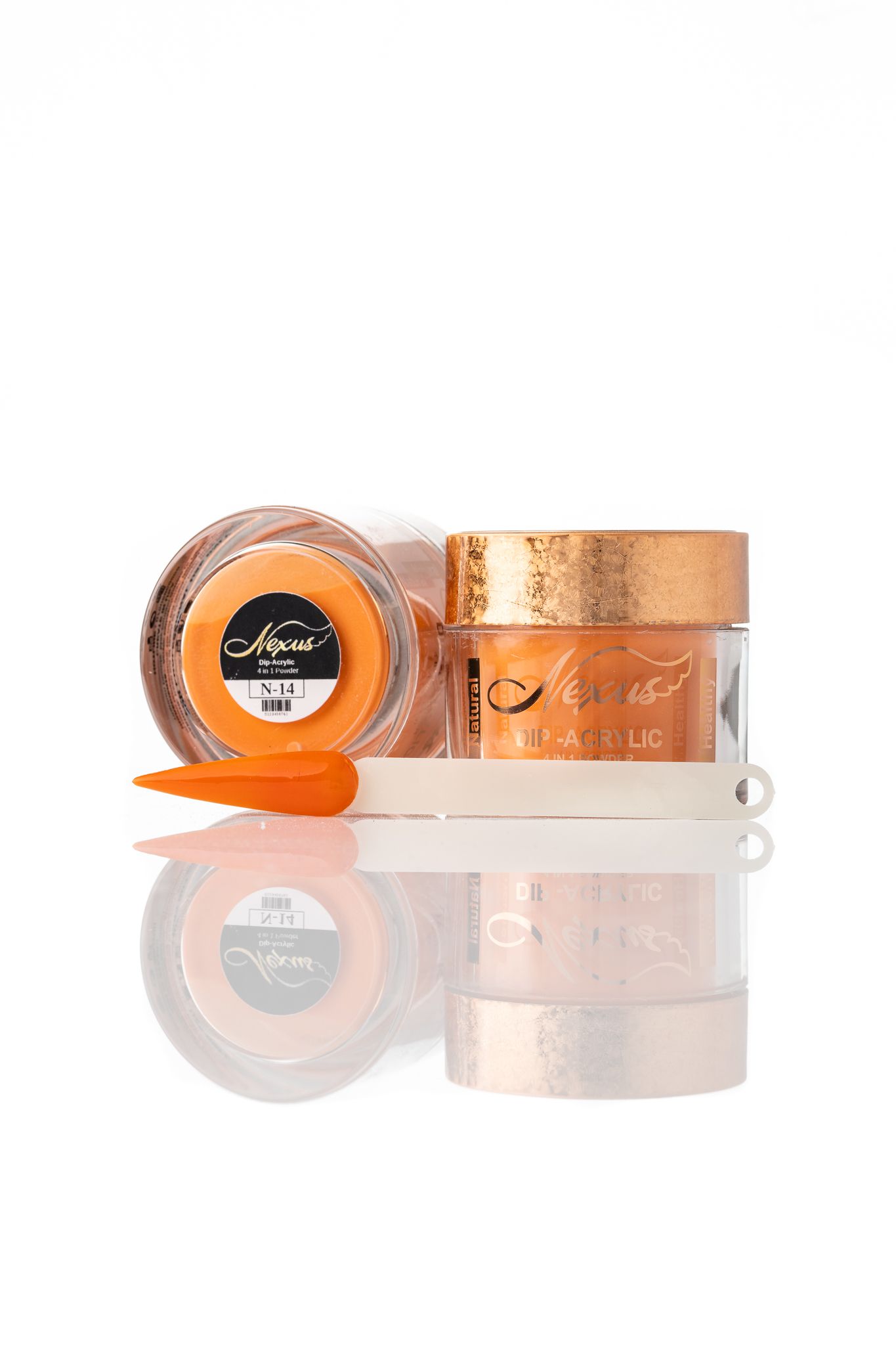 Nexus dip-acrylic nail powder jars in orange with colour swatch tip on a reflective white surface, beauty product photography Southampton