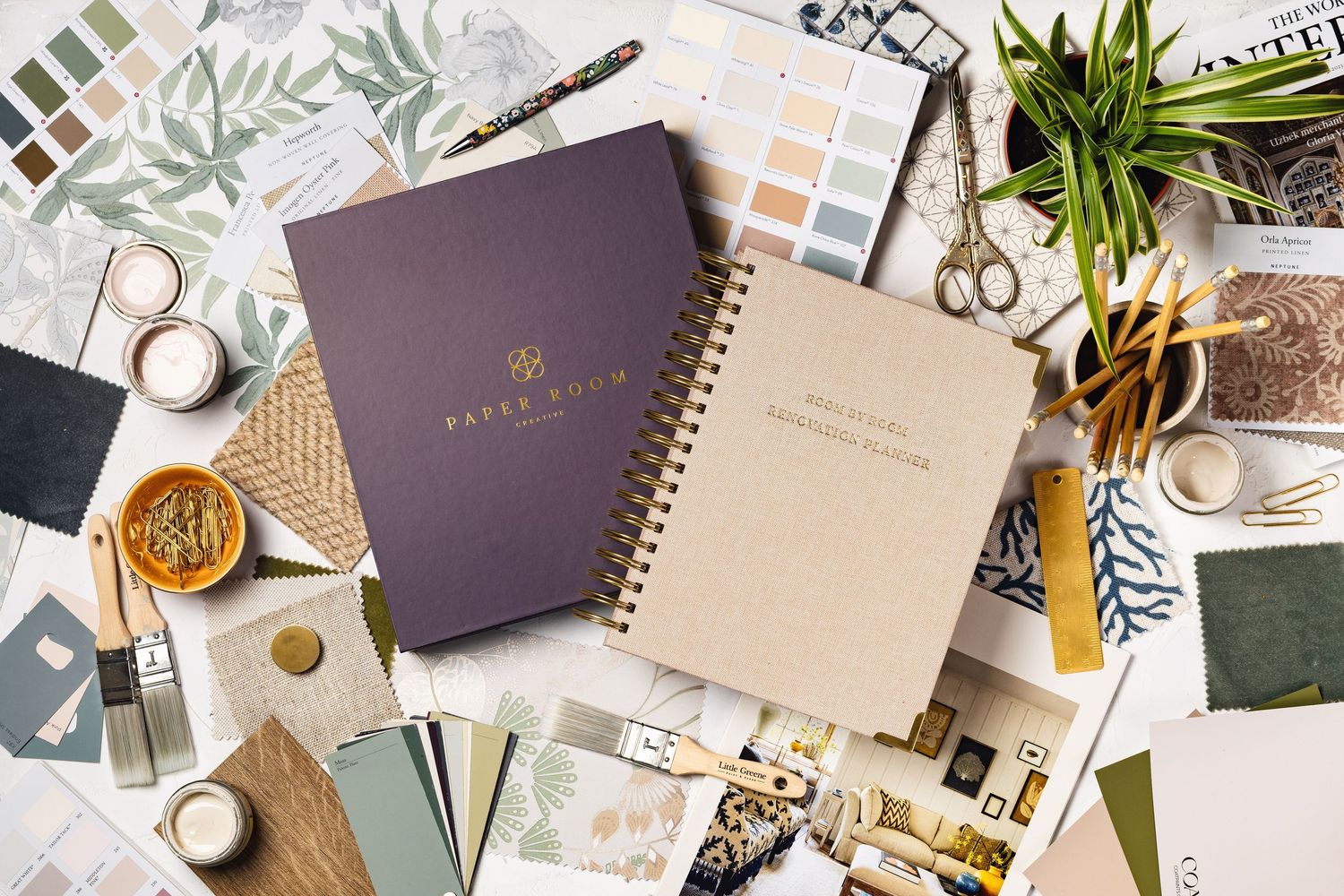 Interior design flat-lay with Paper Room notebook, Room by Room renovation planner, fabric swatches, paint samples and styling accessories, branding product photography