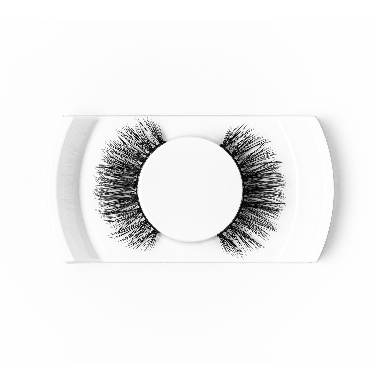 False eyelash pair on a white tray photographed from above on a white background, minimalist beauty product photography Southampton