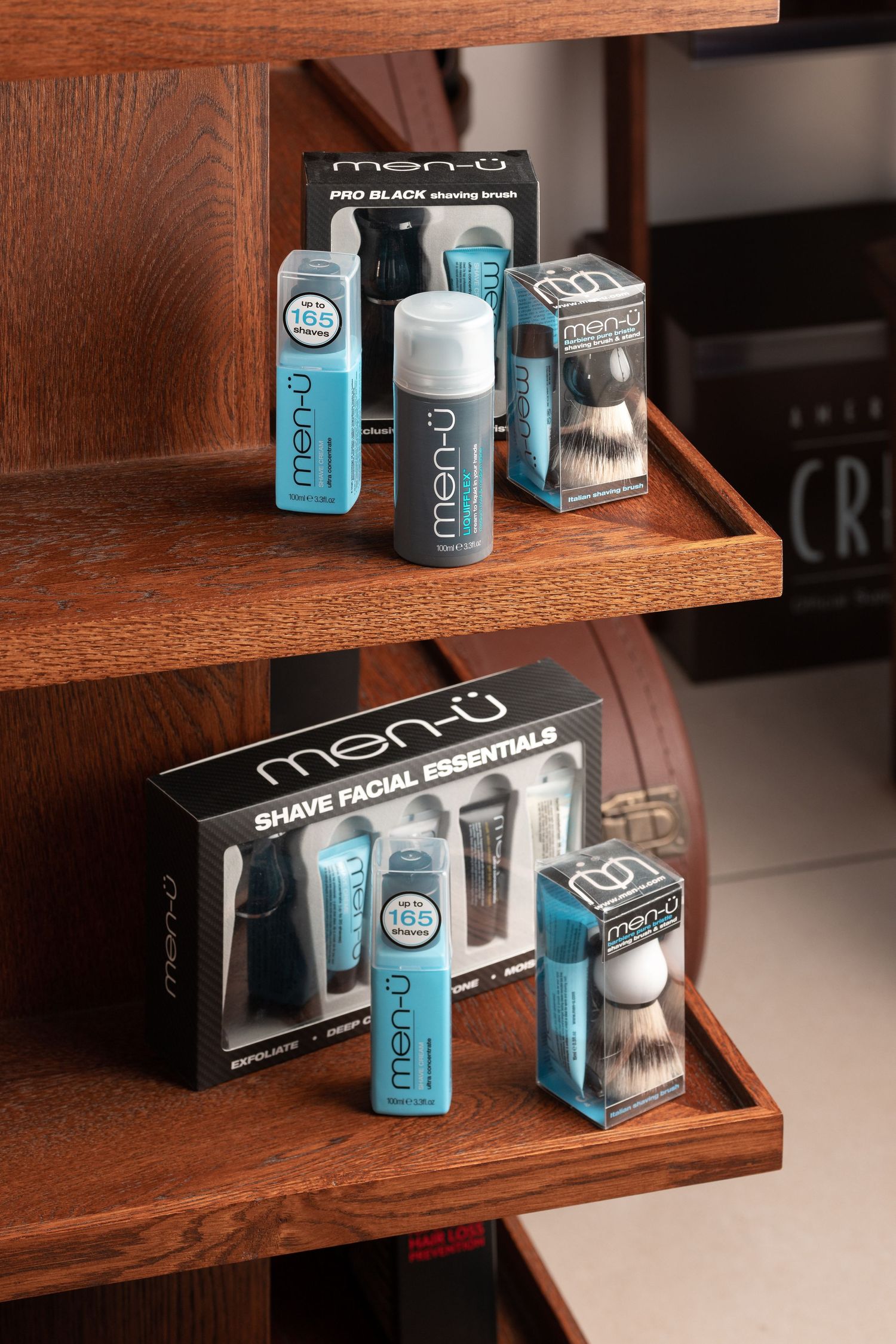 Men-u shaving and grooming products displayed on wooden shelves at Above Barbers salon Southampton, haircare product photography