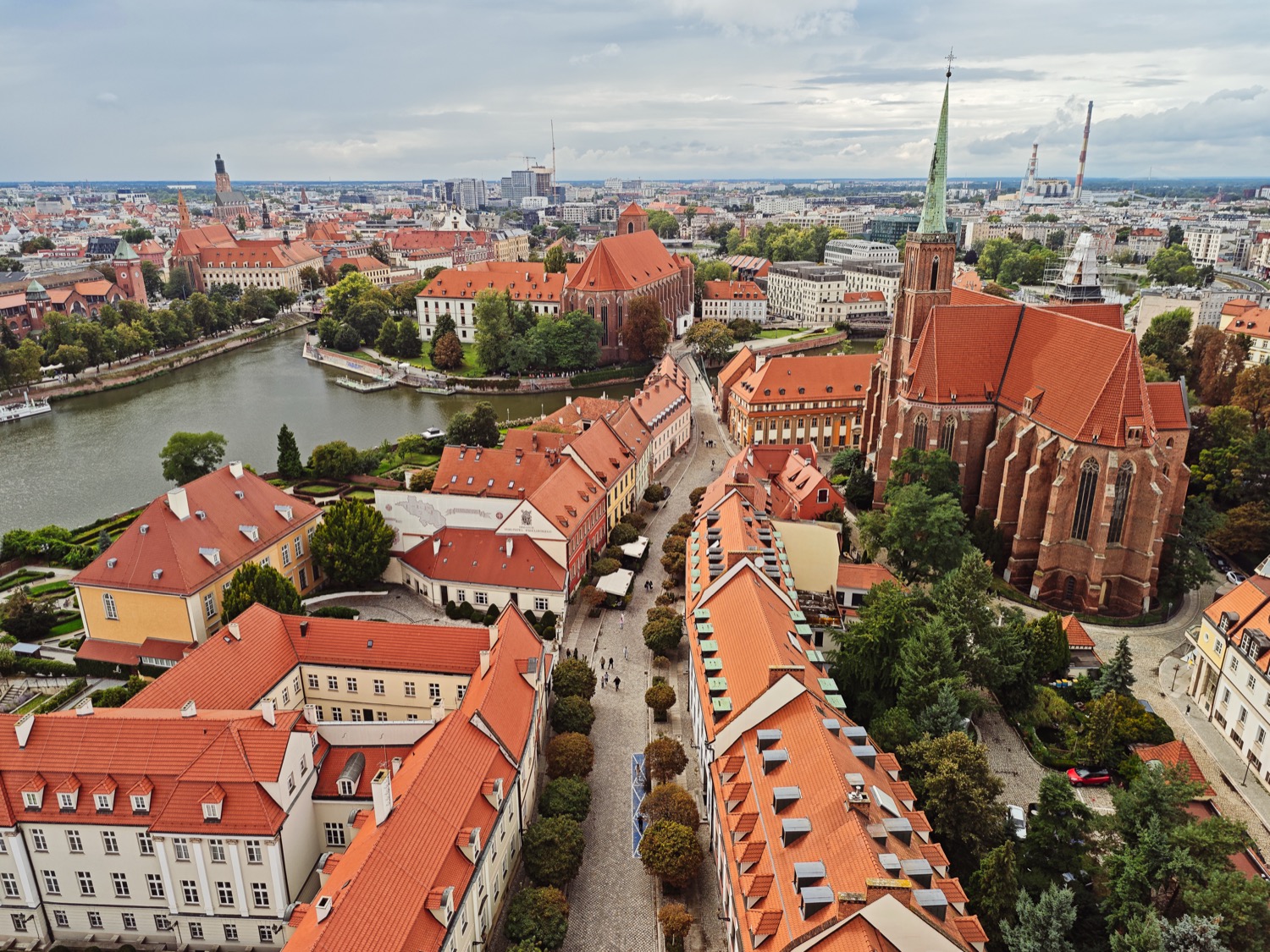 Aerial view over the river with red rooftops and a brick church, Wroclaw, Poland, travel photography