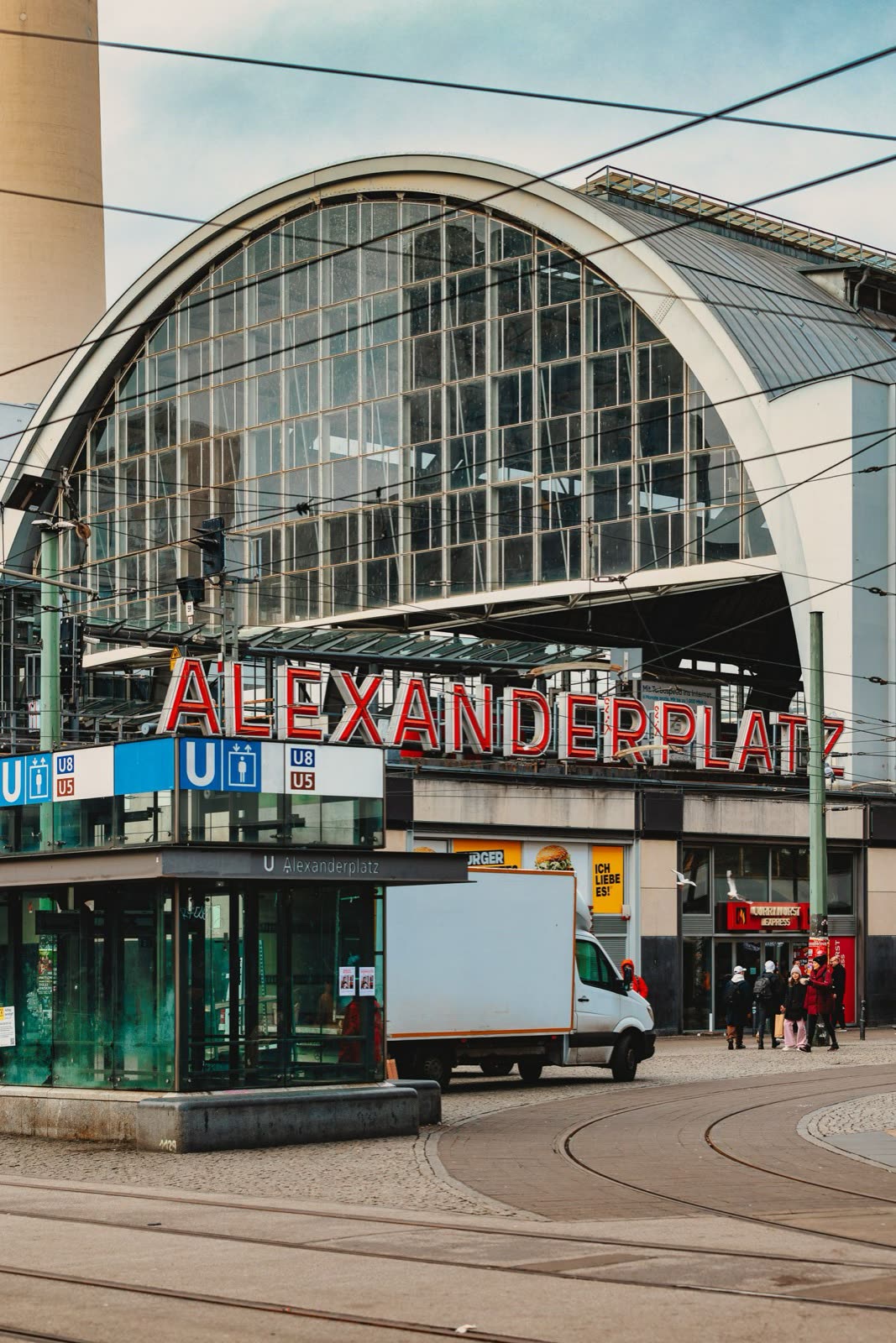 Alexanderplatz station, its arched glass frontage and red lettering above the tram tracks, Berlin, Germany, travel photography