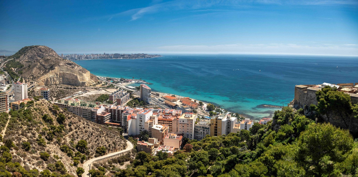 Panorama of the bay, beach and wooded hillside above the city, Alicante, Spain, travel photography
