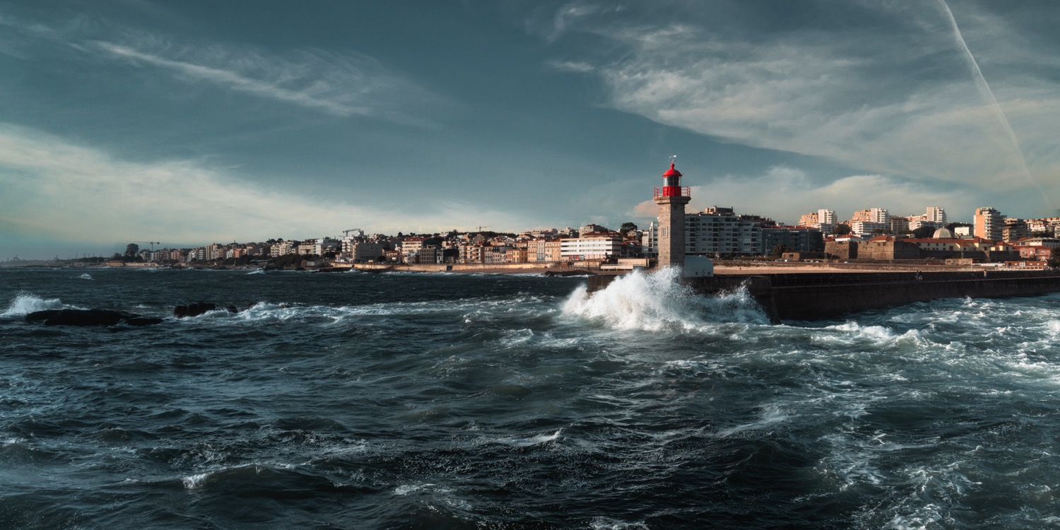Panorama of the breakwater, Felgueiras lighthouse and coastline in heavy seas, Foz do Douro, Porto, Portugal, travel photography
