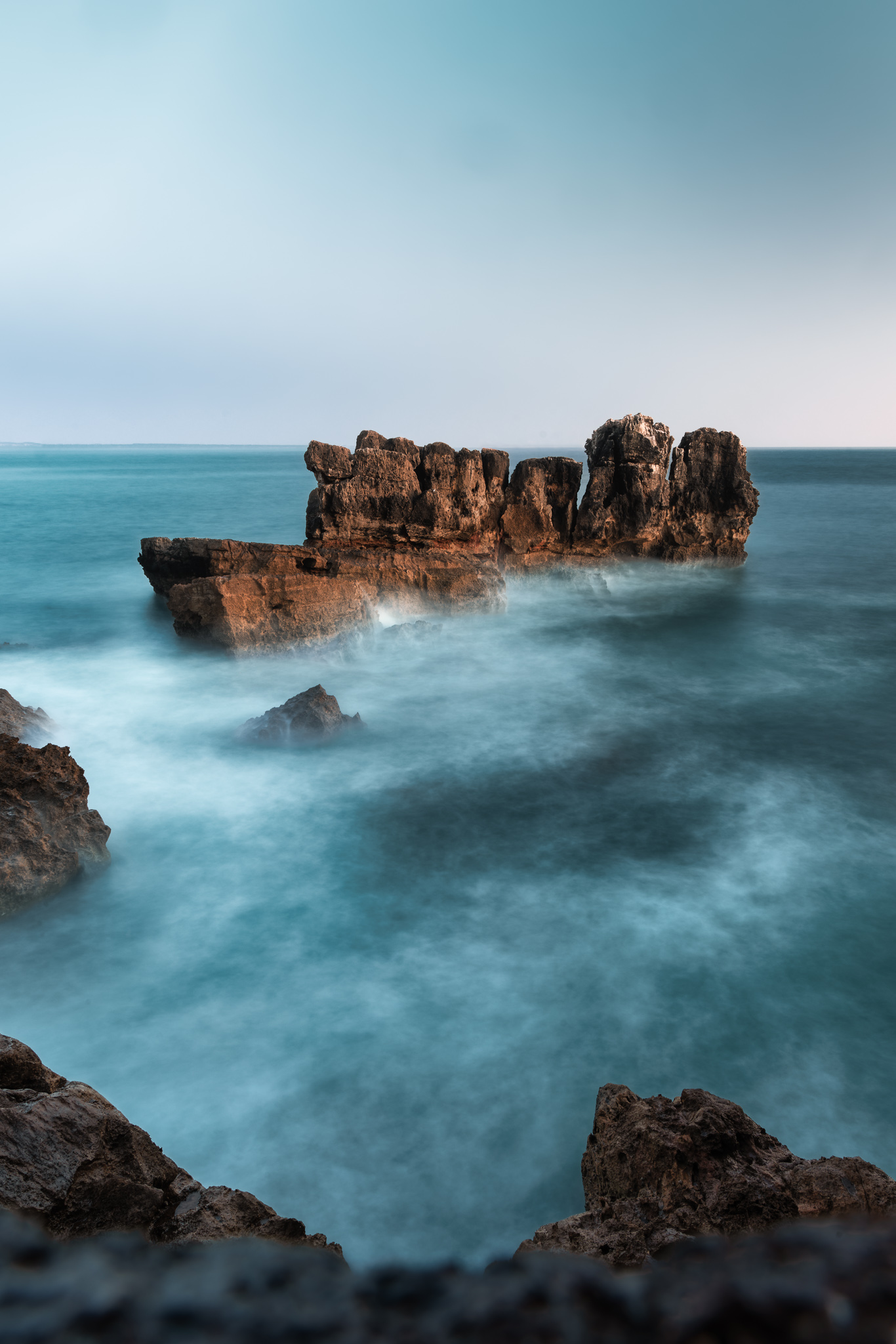 Long exposure of sea stacks with the water smoothed to mist, Atlantic coast, Portugal, travel photography