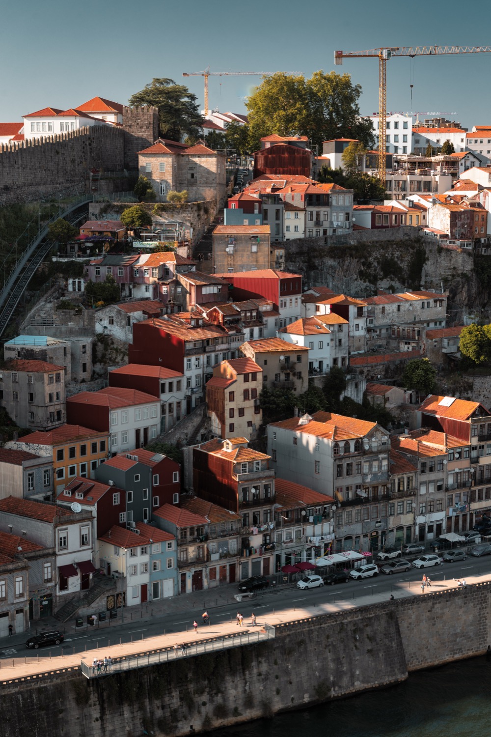 Houses stacked up the hillside above the Douro beside the Muralha Fernandina, Porto, Portugal, travel photography