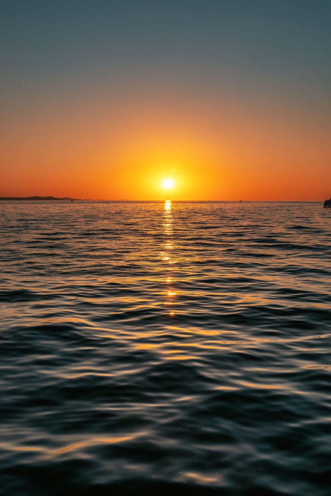 The sun dropping to the horizon over a calm Adriatic, Zadar, Croatia, travel photography