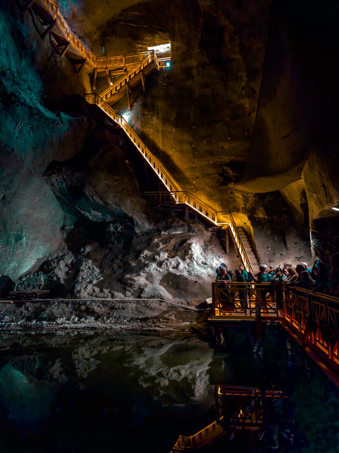 Underground chamber in a salt mine with timber walkways and lit rock faces, Poland, travel photography